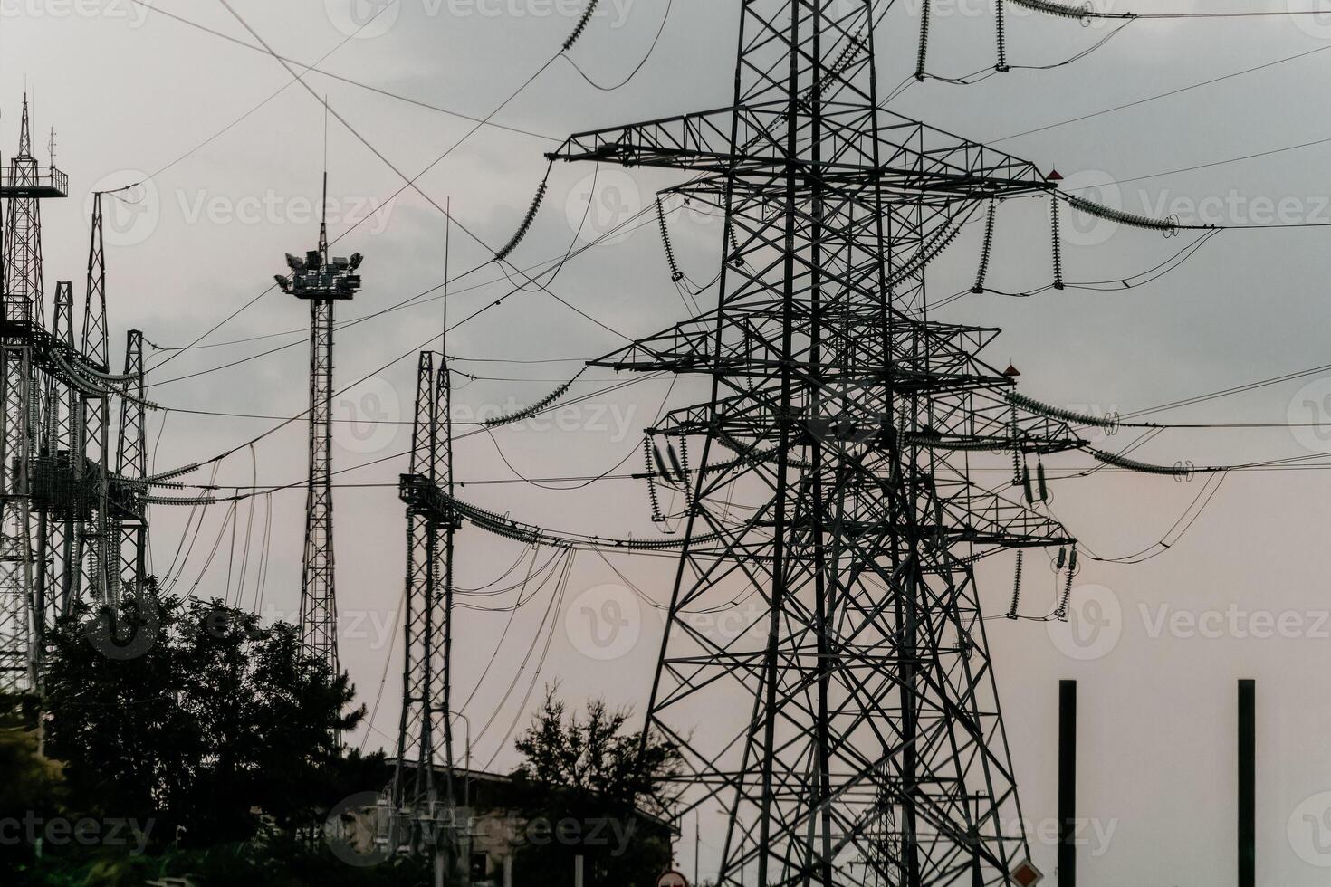 Power Lines and Towers Under a Cloudy Sky photo