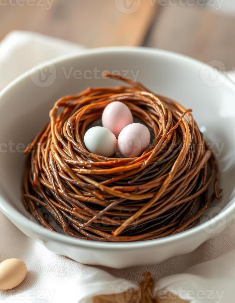 Decorative bird's nest with three eggs resting on a wooden table in a cozy setting photo