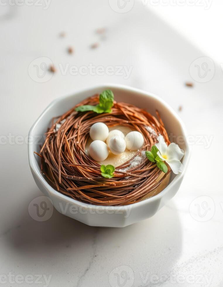 Delicious dessert in a decorative bowl resembling a bird's nest with chocolate and white candy eggs photo