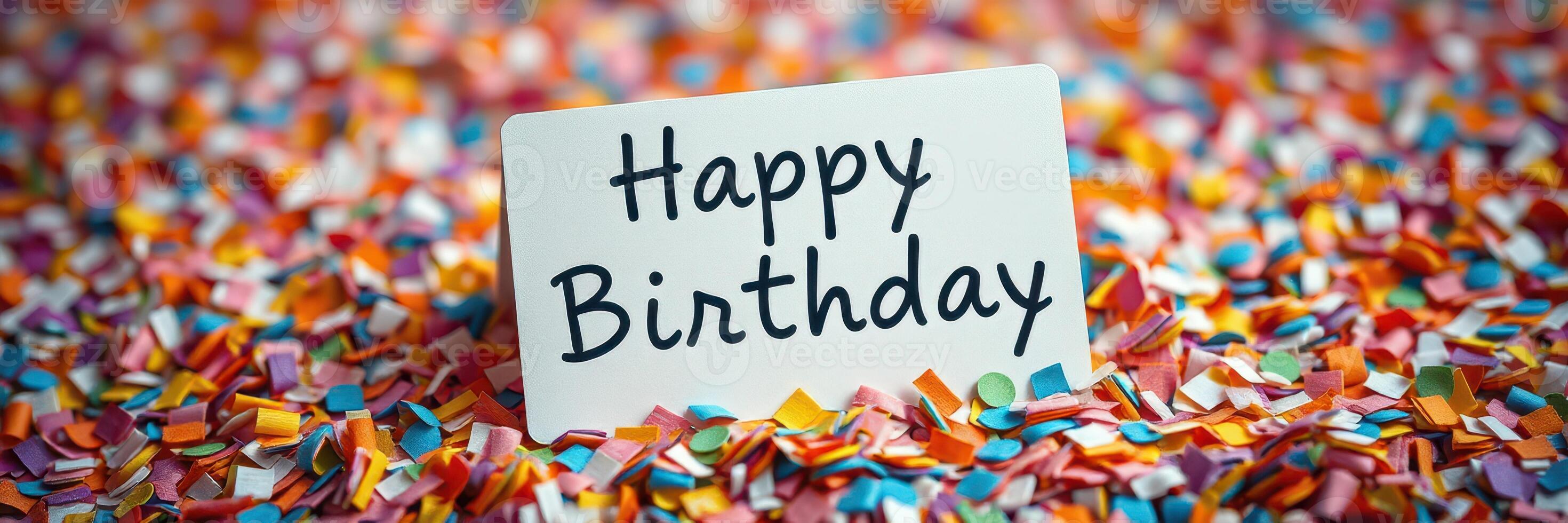 Brightly colored confetti surrounds a card that expresses warm birthday wishes on a celebratory occasion photo