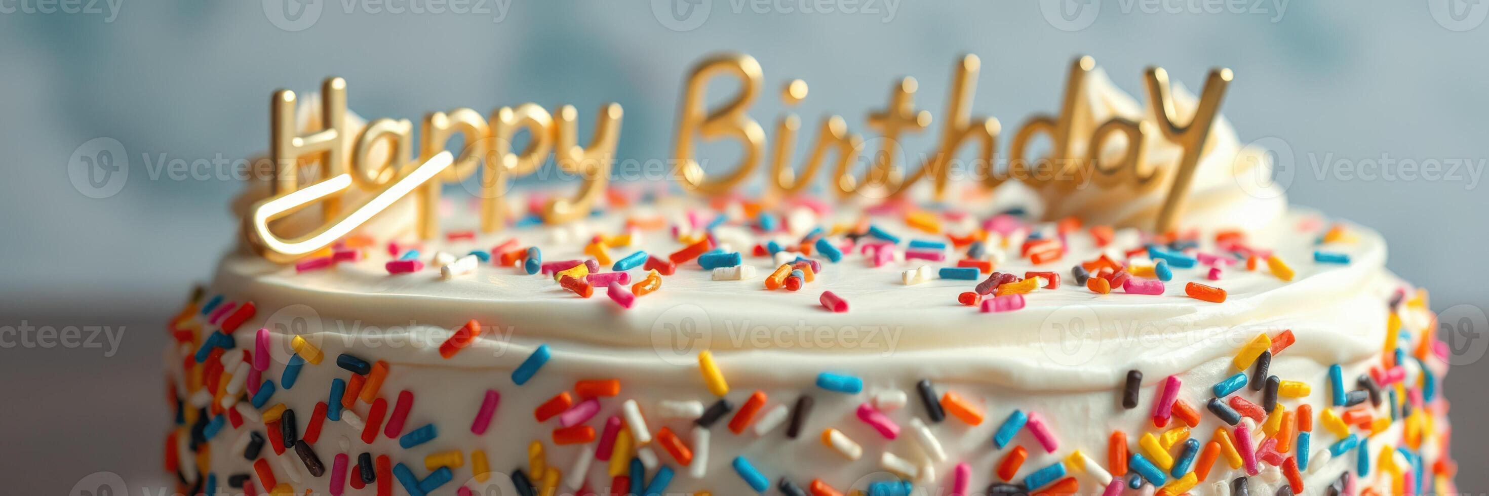 Colorful birthday cake celebrates a special occasion with sprinkles and a golden topper photo