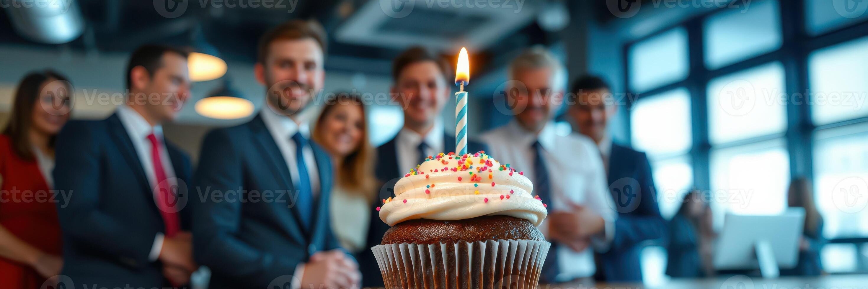 Cupcake celebration with friends and coworkers at a festive birthday gathering in a modern office setting during the day photo