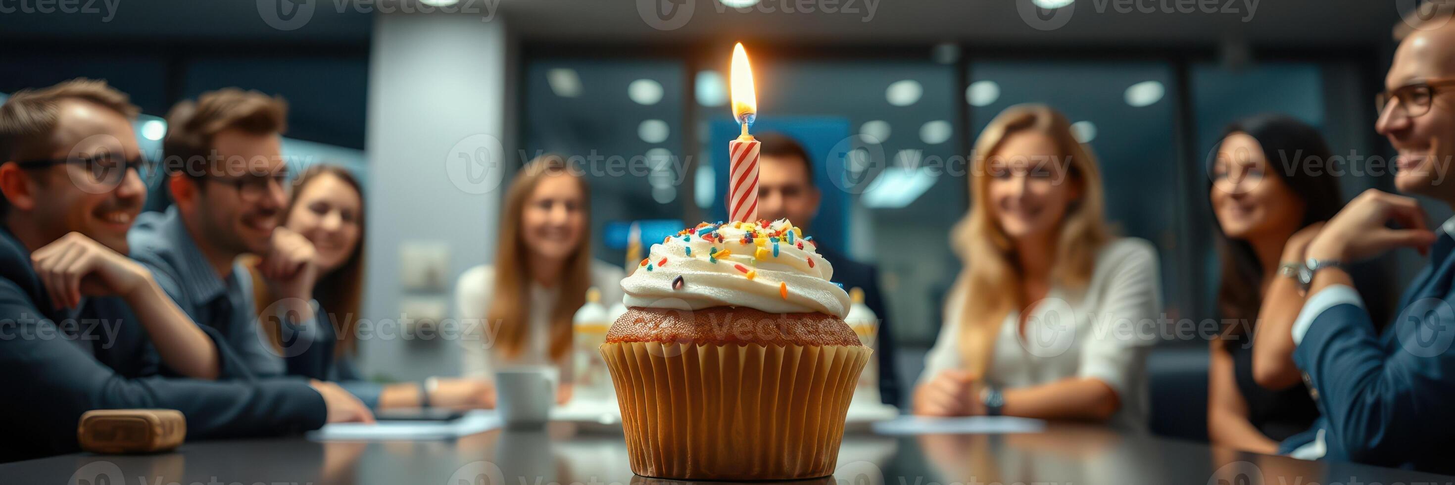 Celebrating a birthday with friends in a modern office setting featuring a colorful cupcake photo