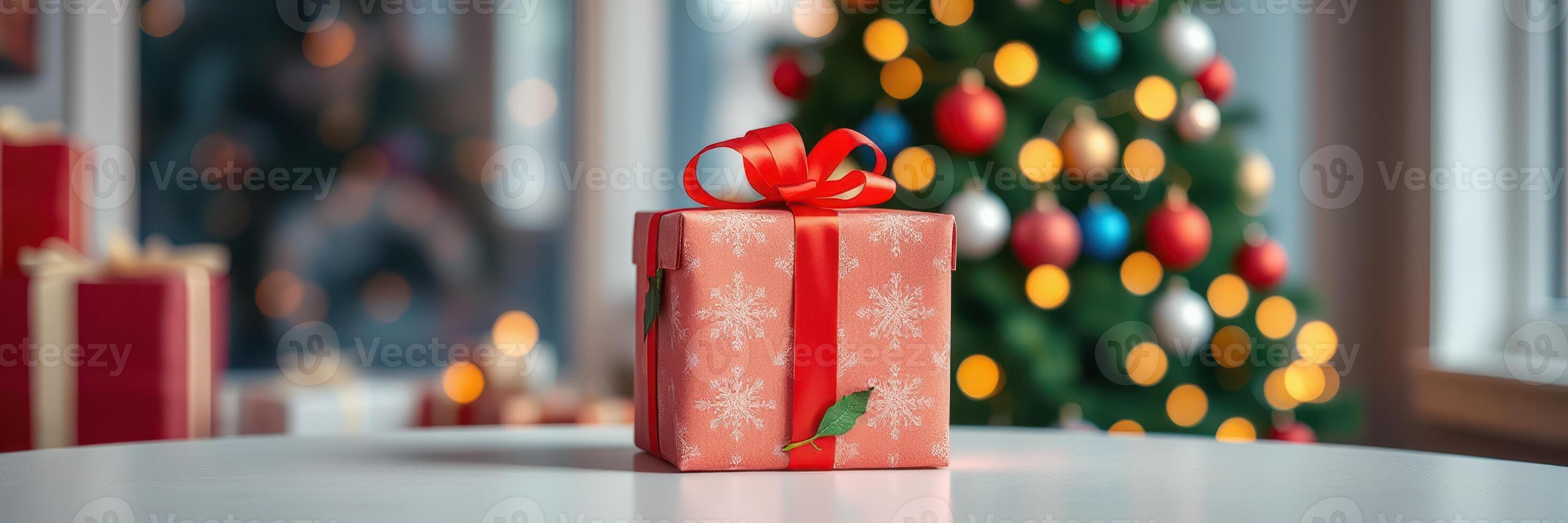 A beautifully wrapped gift placed on a table in front of a decorated Christmas tree with colorful lights and ornaments in a cozy setting photo