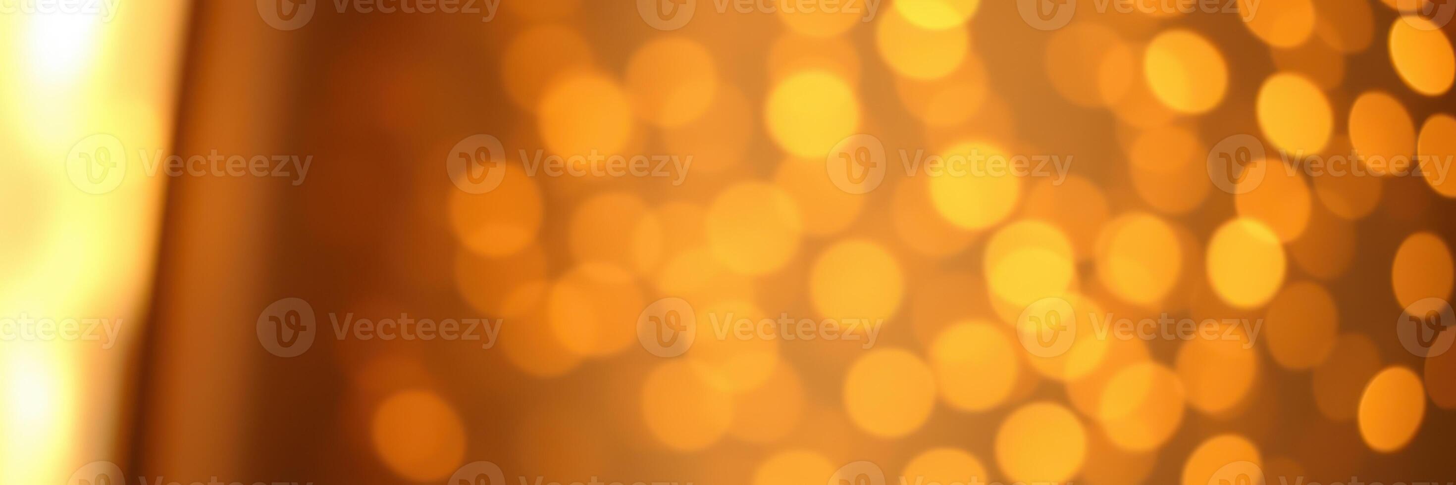 Warm golden bokeh lights create a cozy atmosphere during a festive evening celebration photo