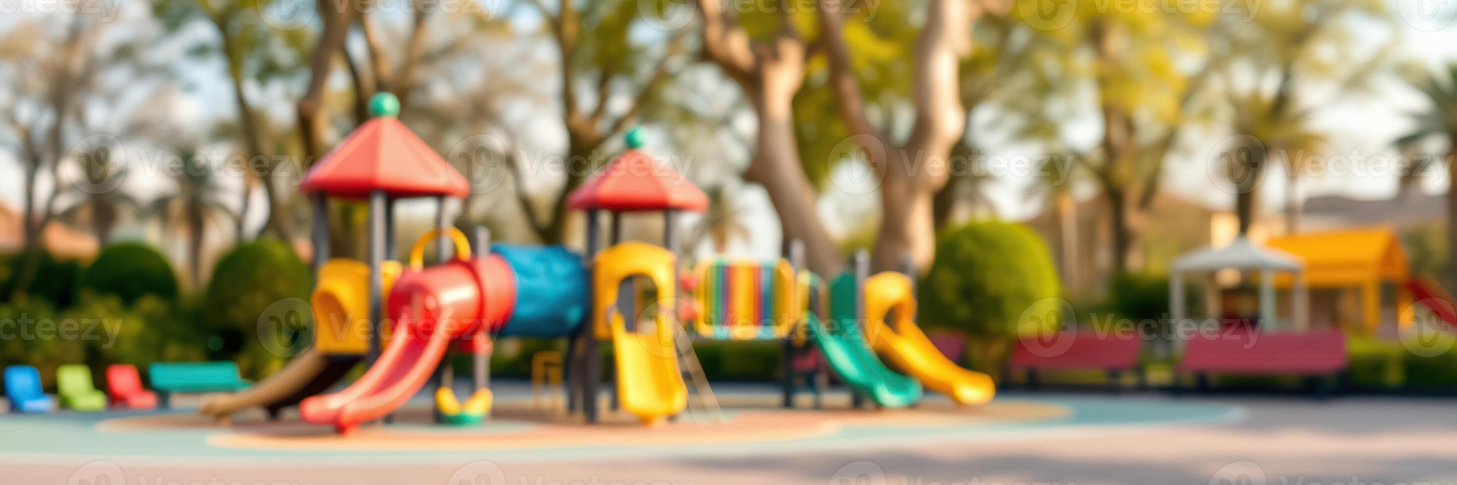 Colorful playground equipment in a sunny park with trees and seating areas for families to enjoy photo