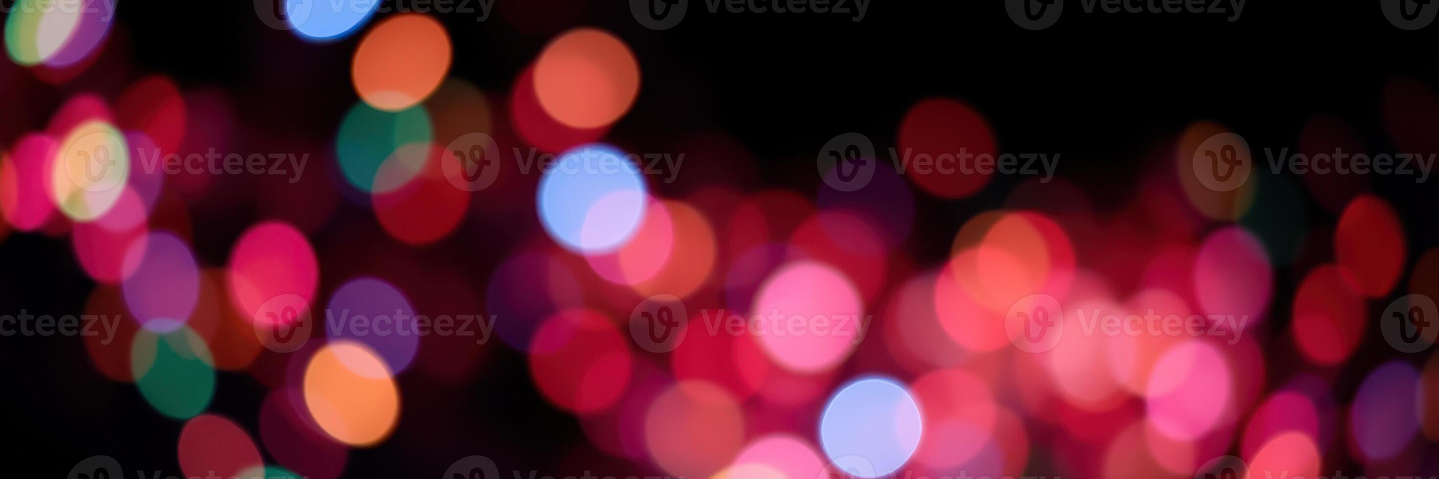 Colorful bokeh lights create a festive atmosphere during a nighttime celebration in the city photo