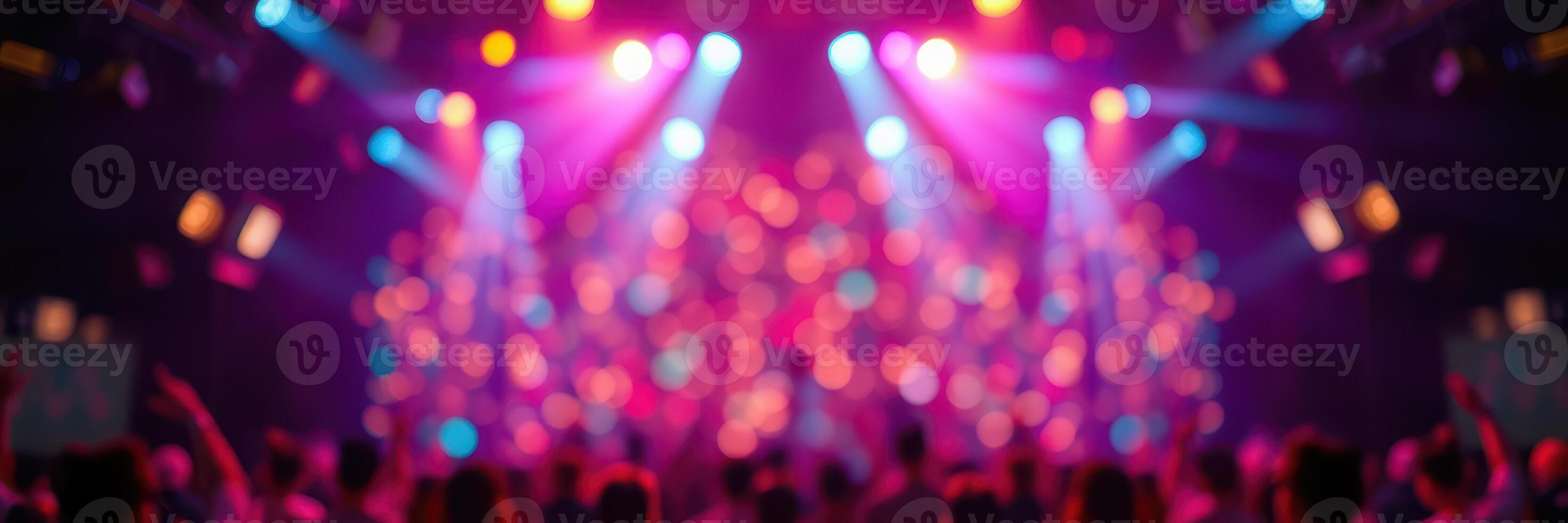 Colorful lights illuminate a lively concert atmosphere with an excited crowd celebrating music and energy in an urban venue photo