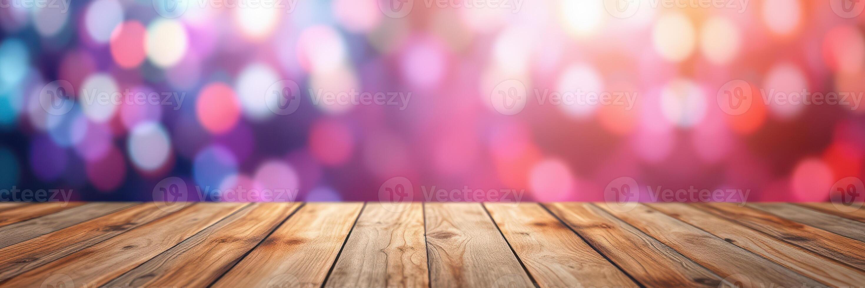 Colorful bokeh background with wooden table surface for creative display or product presentation photo
