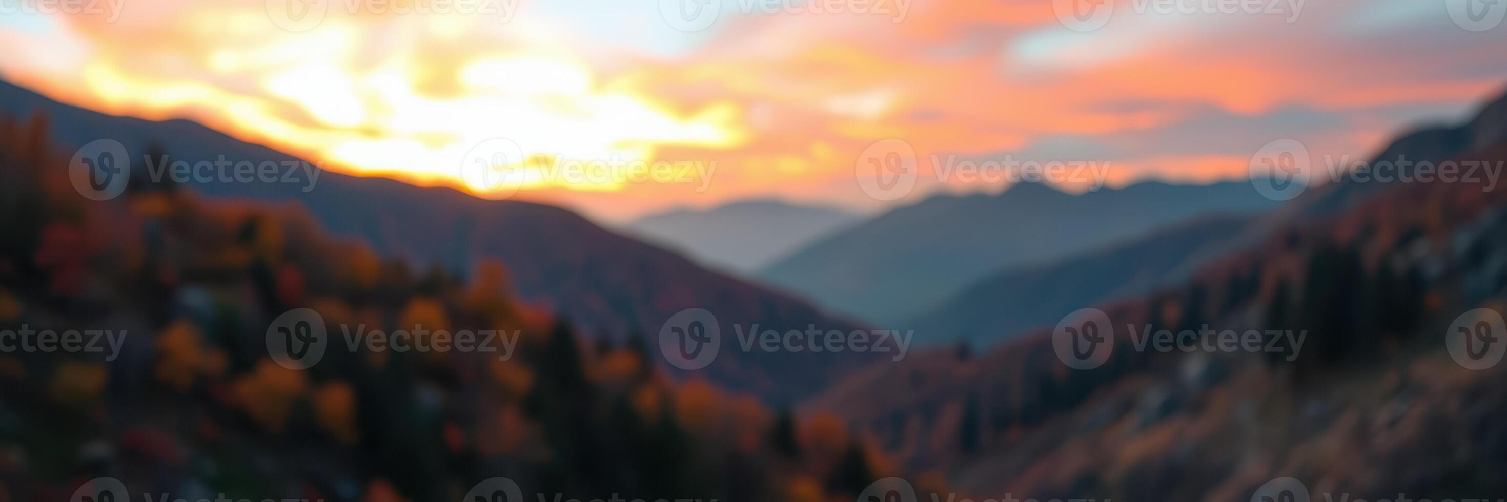 Sunset over mountain valleys creates vibrant hues in the sky amid beautiful autumn foliage and distant peaks photo