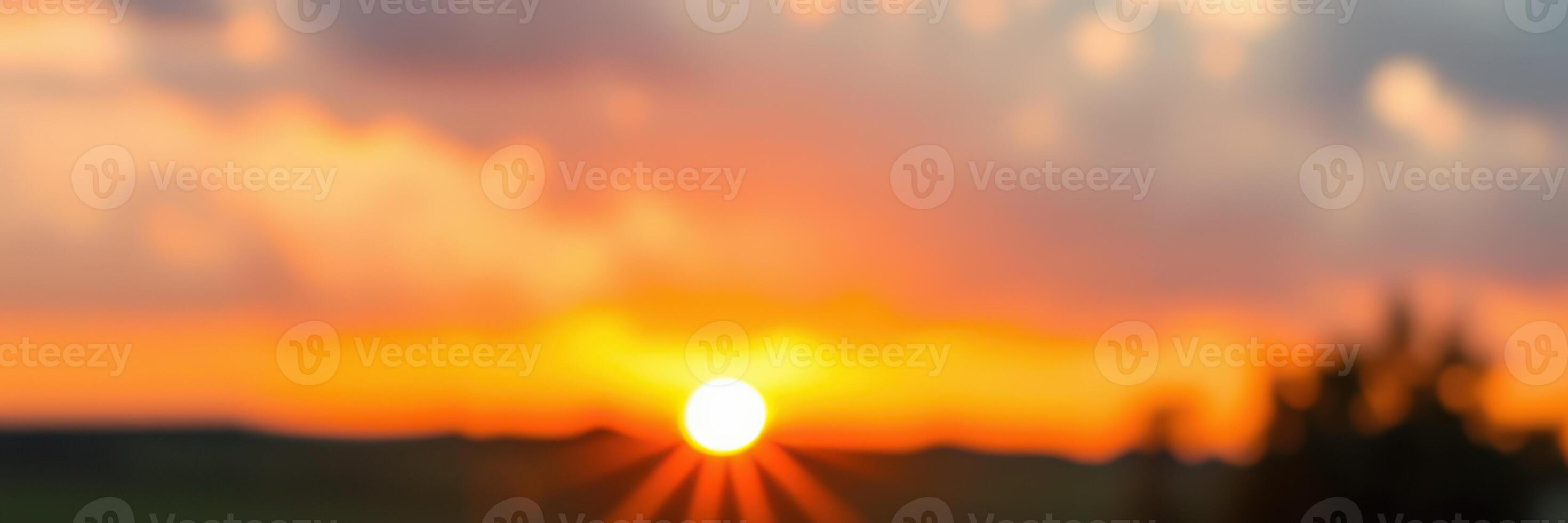 Stunning sunset over a horizon with vibrant colors and rays illuminating the sky during evening hours photo