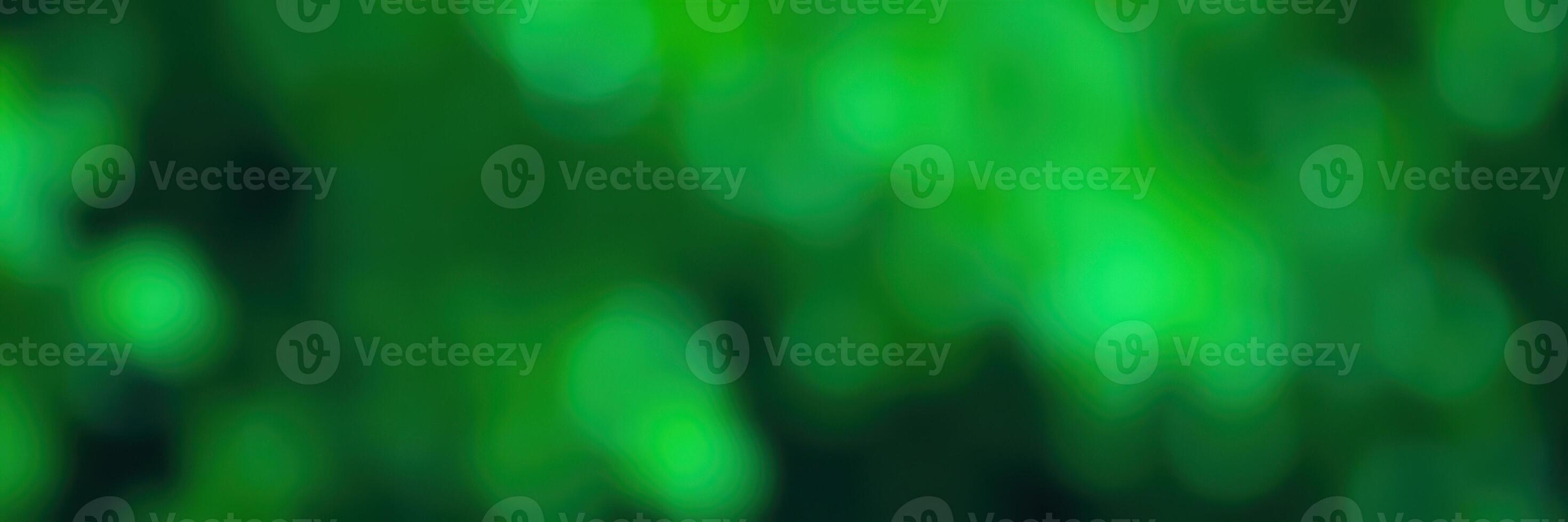 Green bokeh effect creates a dreamy atmosphere in a forested area during daylight hours photo