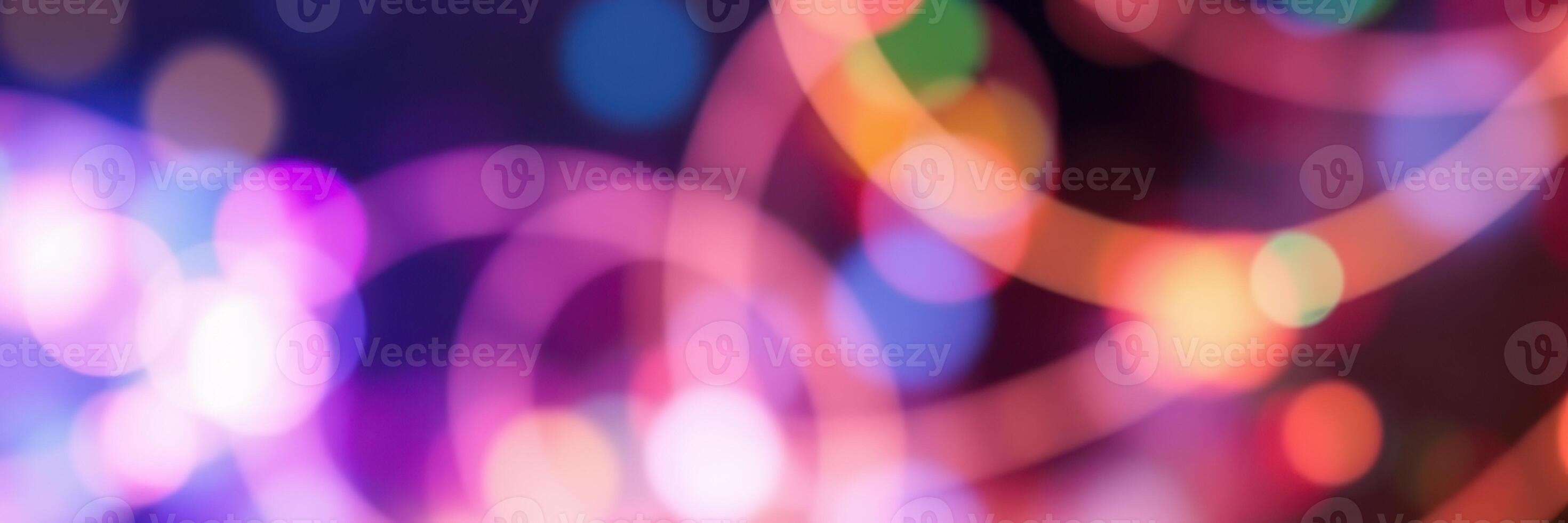 Colorful light patterns create a vibrant atmosphere at a lively nighttime celebration photo