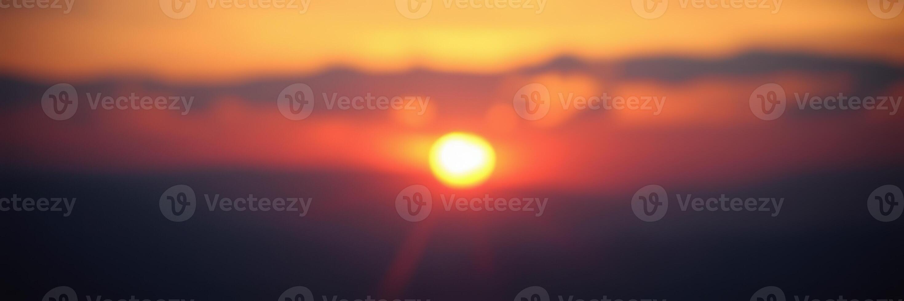 Sunset casts vibrant colors across the sky over a tranquil landscape at dusk photo