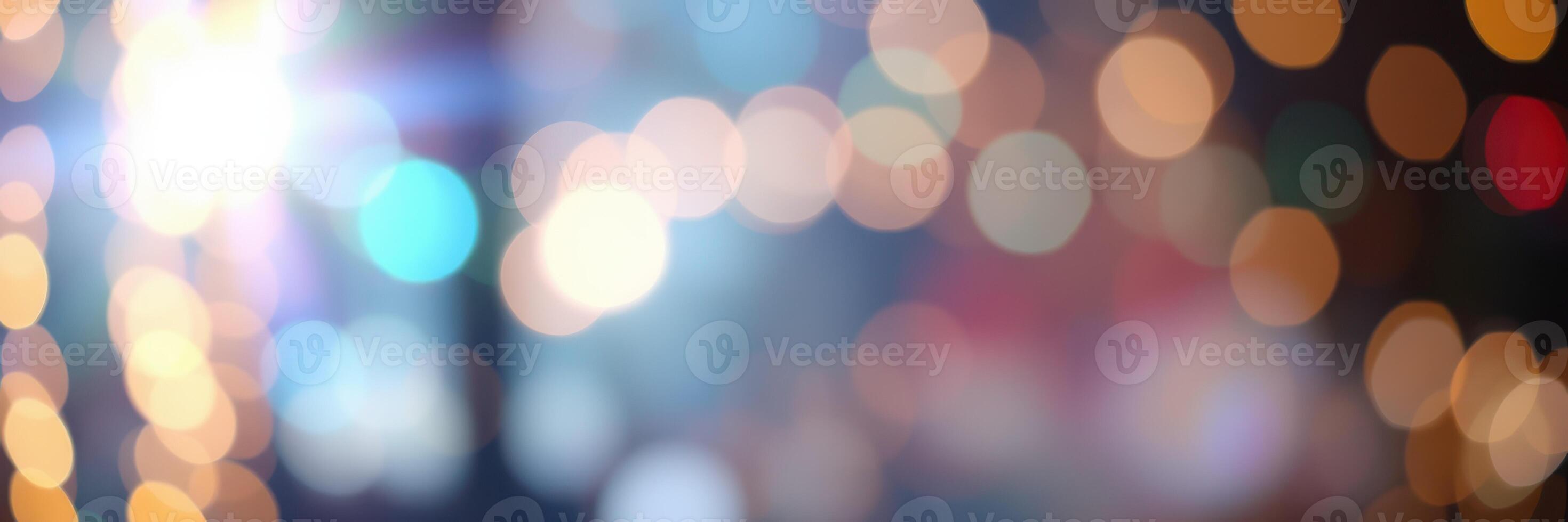 Colorful bokeh lights create a festive atmosphere in a city street during an evening celebration photo