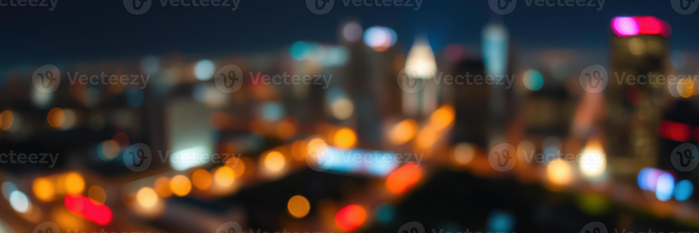 City skyline illuminated at night with colorful lights and a vibrant urban atmosphere photo