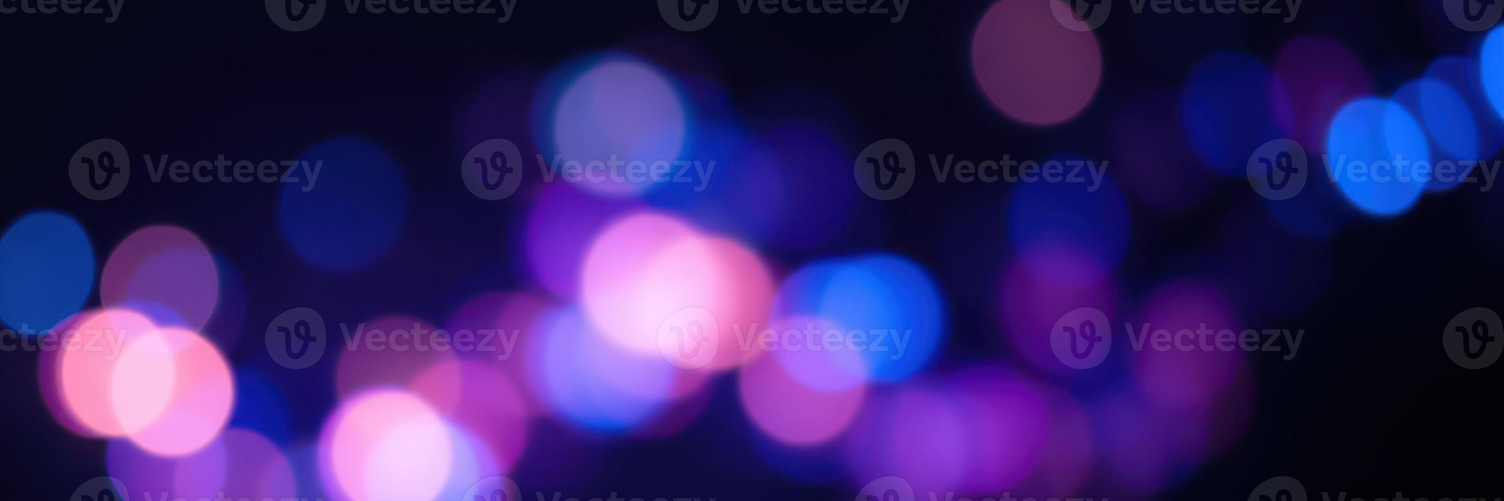 Colorful bokeh lights create a captivating atmosphere at night shimmering in shades of blue and purple photo