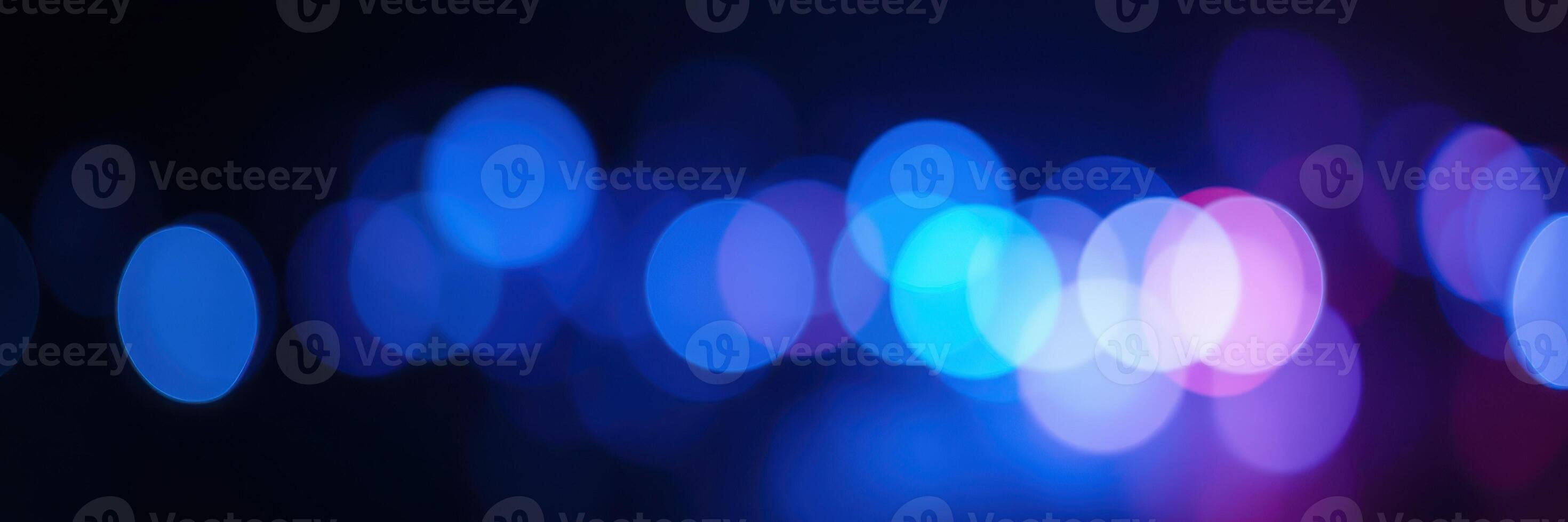 Colorful bokeh lights create a vibrant and blurry background at an evening event photo