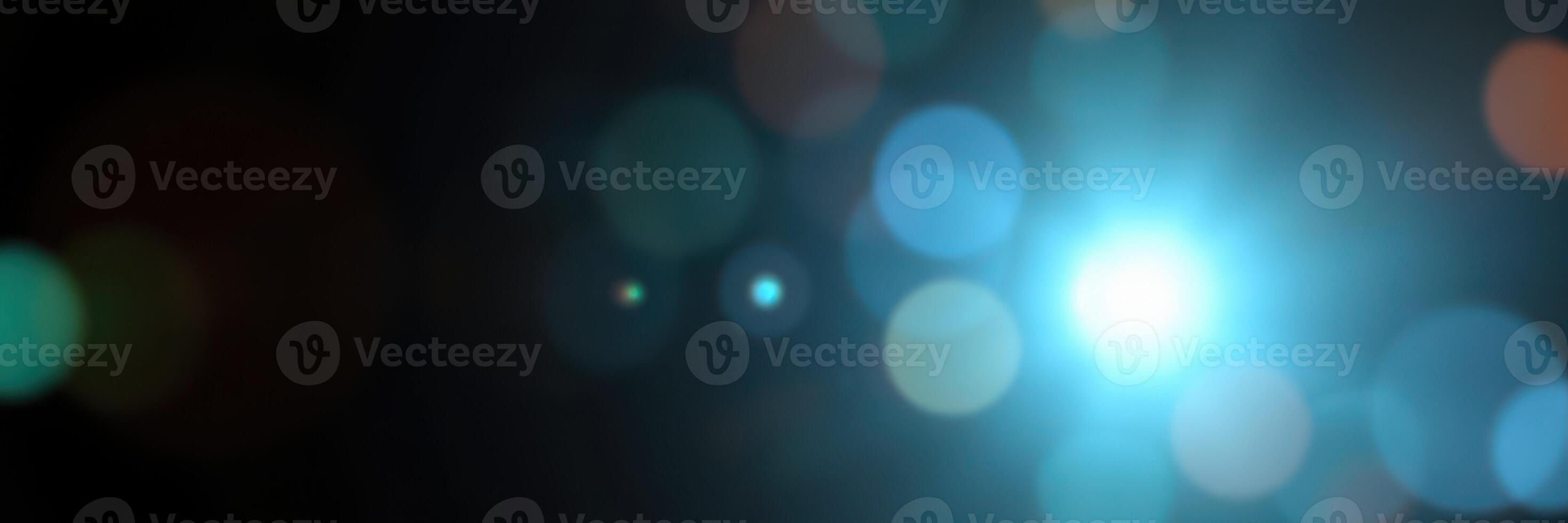 Light particles create a mesmerizing visual effect in a dark environment with vibrant blue highlights and soft bokeh photo