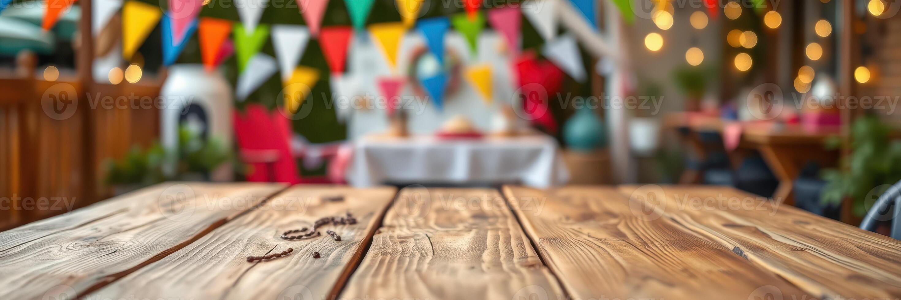 Rustic wooden table adorned with colorful bunting in a festive outdoor setting during a summer gathering photo