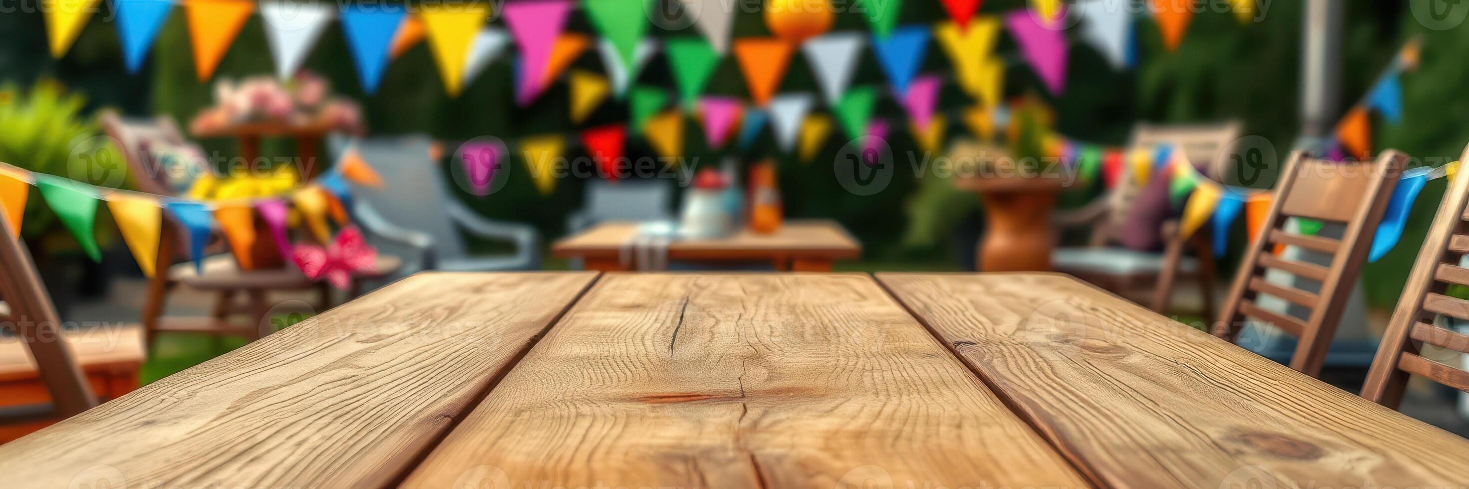 Colorful decorations create a festive atmosphere at an outdoor gathering with wooden tables and chairs photo