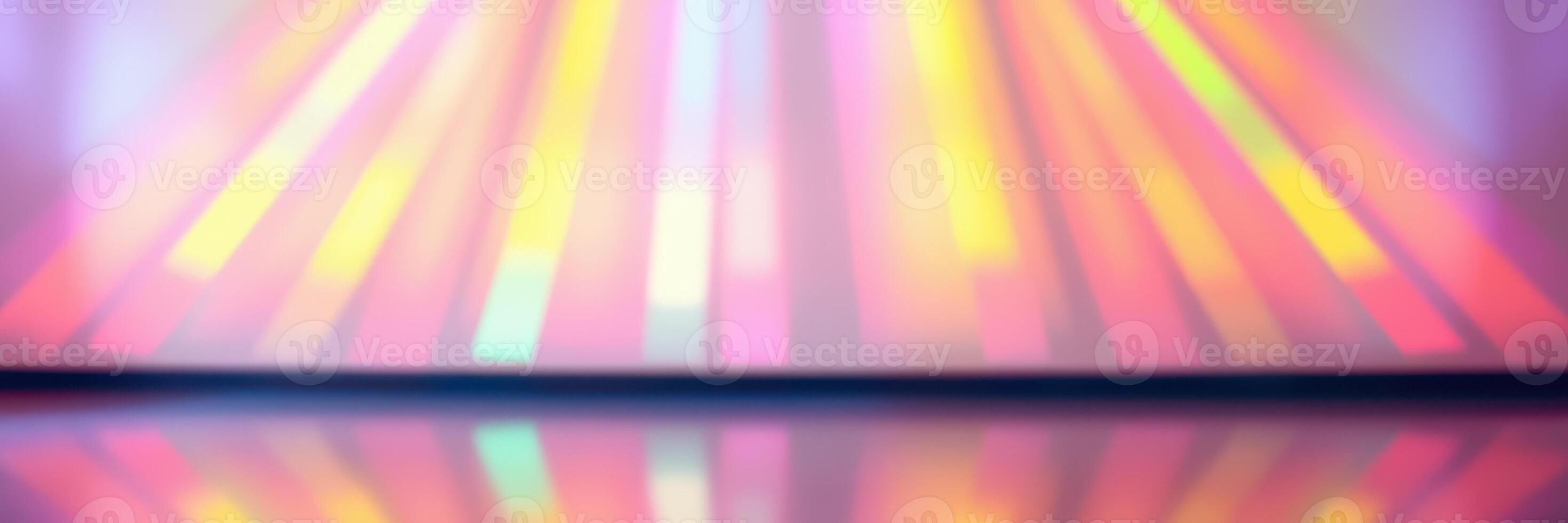 Colorful light rays create vibrant reflections on a glossy surface during an energetic dance performance photo