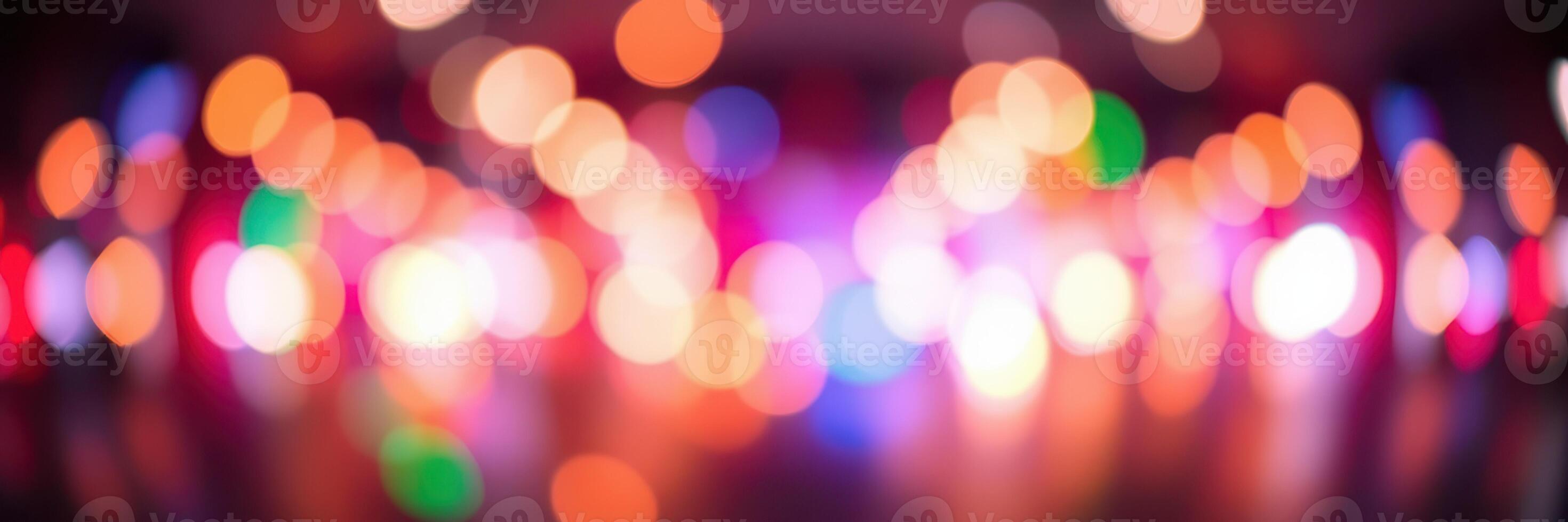 Colorful bokeh lights create a vibrant atmosphere in a lively urban setting at night photo