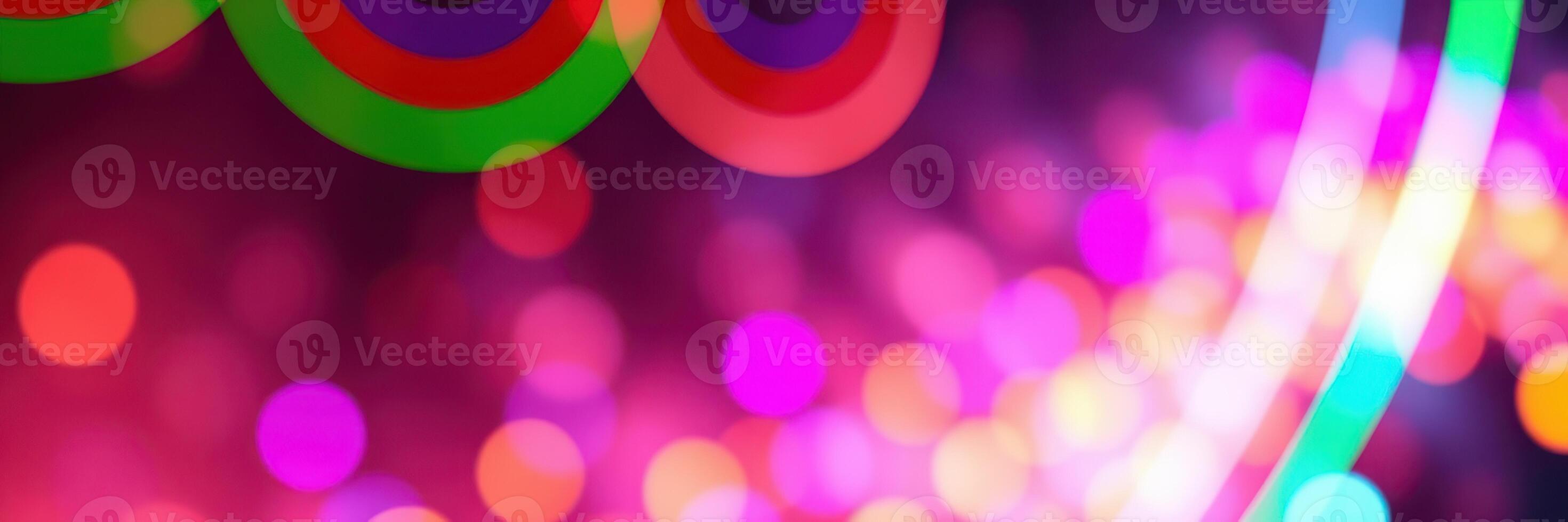 Colorful bokeh lights create a vibrant atmosphere at a nighttime celebration in an urban setting photo
