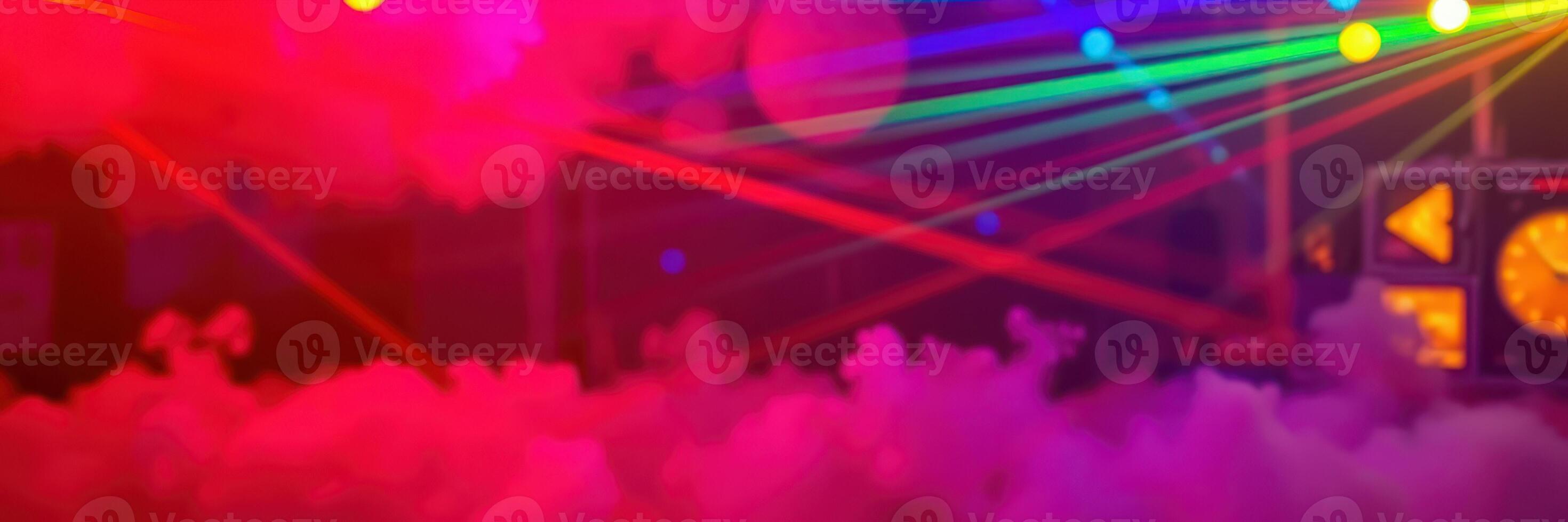Colorful laser lights create a vibrant atmosphere at a dance party in an indoor venue during nighttime photo
