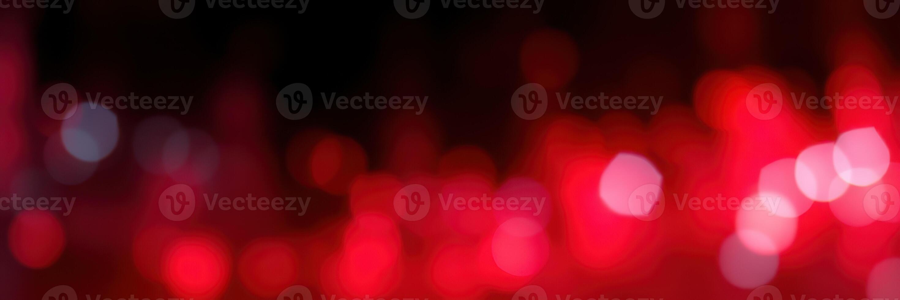 Vibrant red bokeh lights create an abstract atmosphere in a dimly lit space during an evening gathering photo