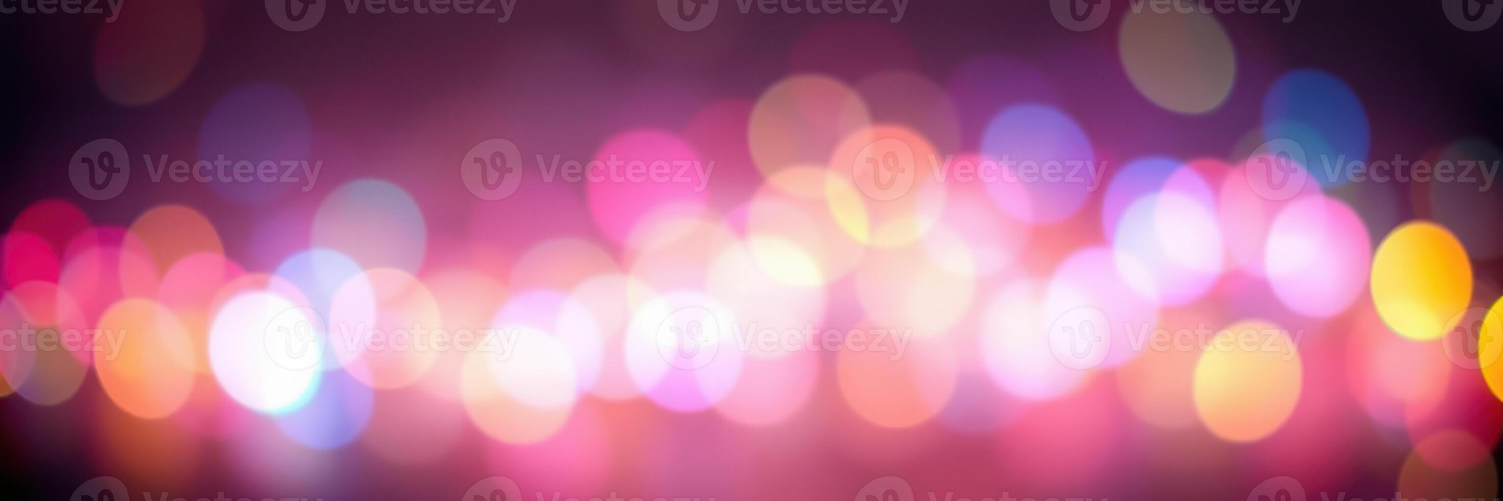 Colorful bokeh lights create a vibrant abstract background during an evening city event photo