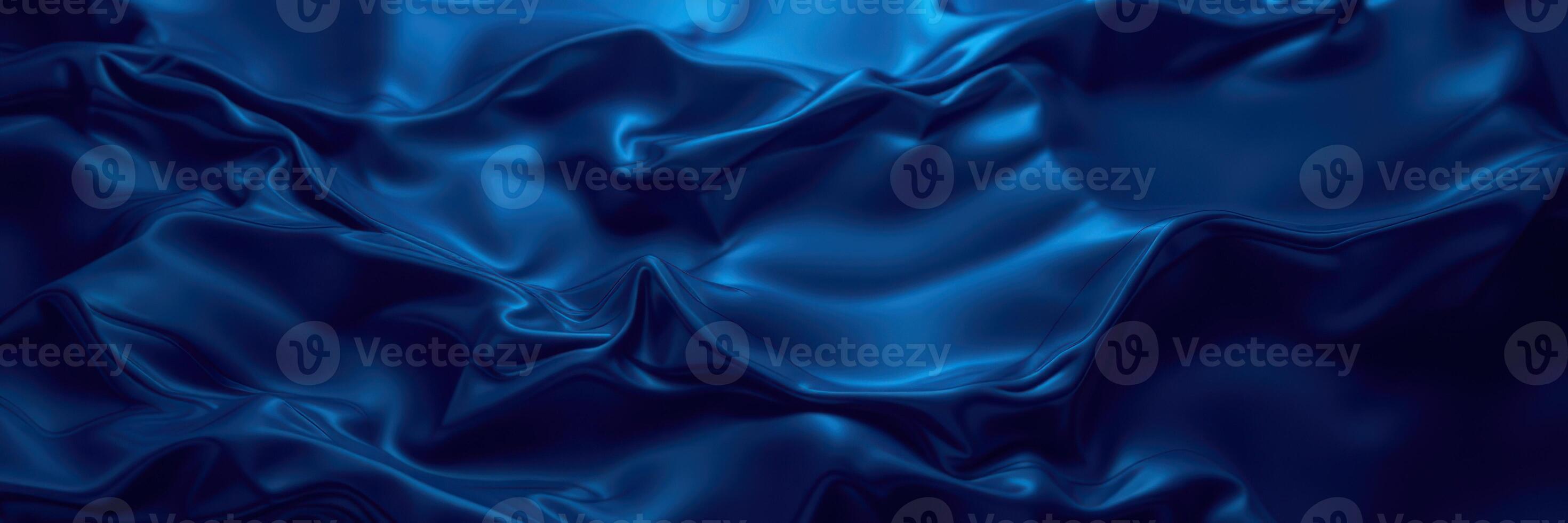 Textured blue silk fabric creating elegant waves and folds in soft lighting, highlighting luxurious appearance photo