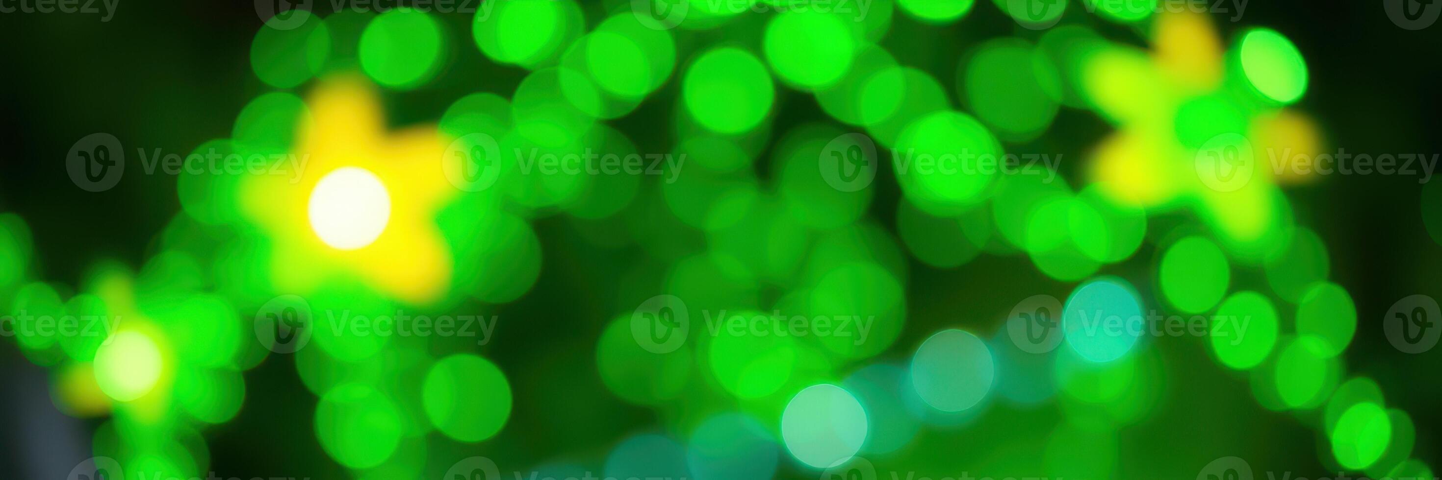 Colorful green lights with yellow stars create a festive atmosphere during a nighttime celebration in a lively outdoor space photo