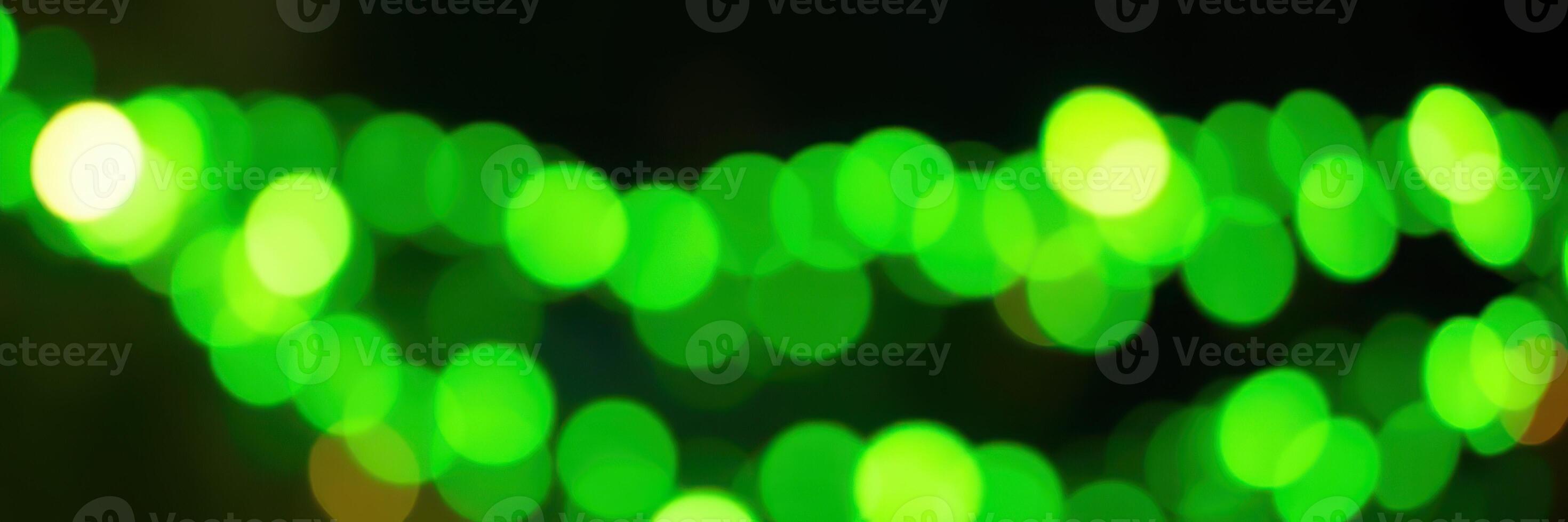 Vibrant green lights create a lively atmosphere at a festive event during an evening gathering in the city photo