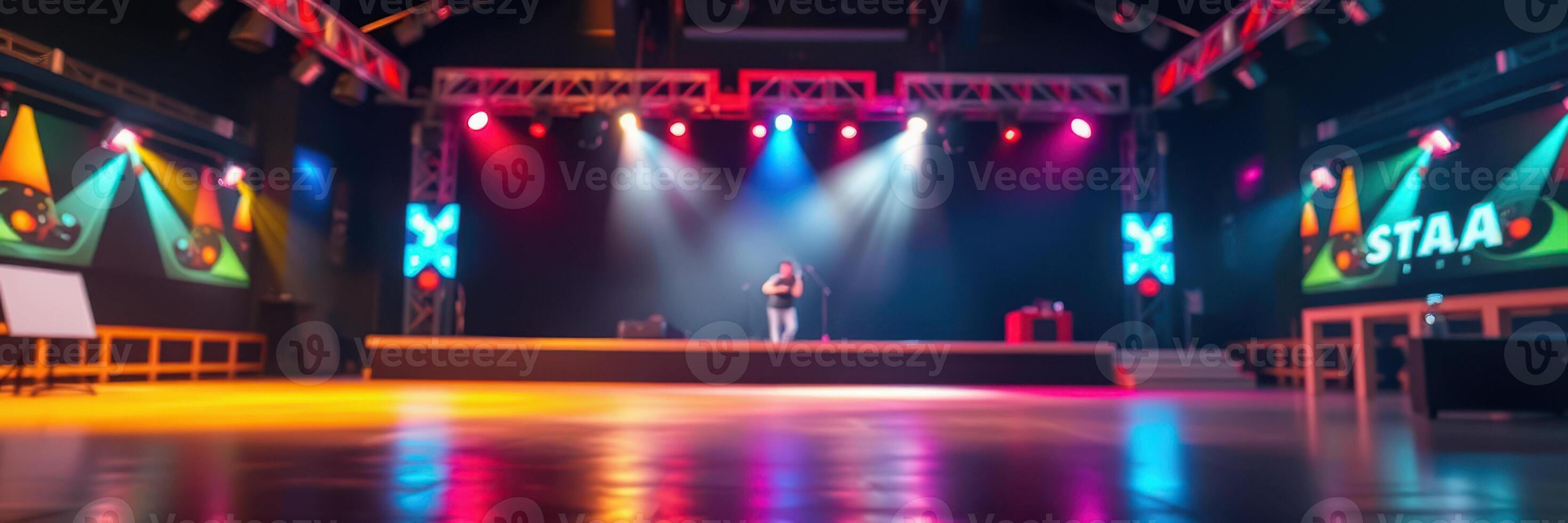 Brightly lit stage hosts performance at a lively event venue in the evening photo