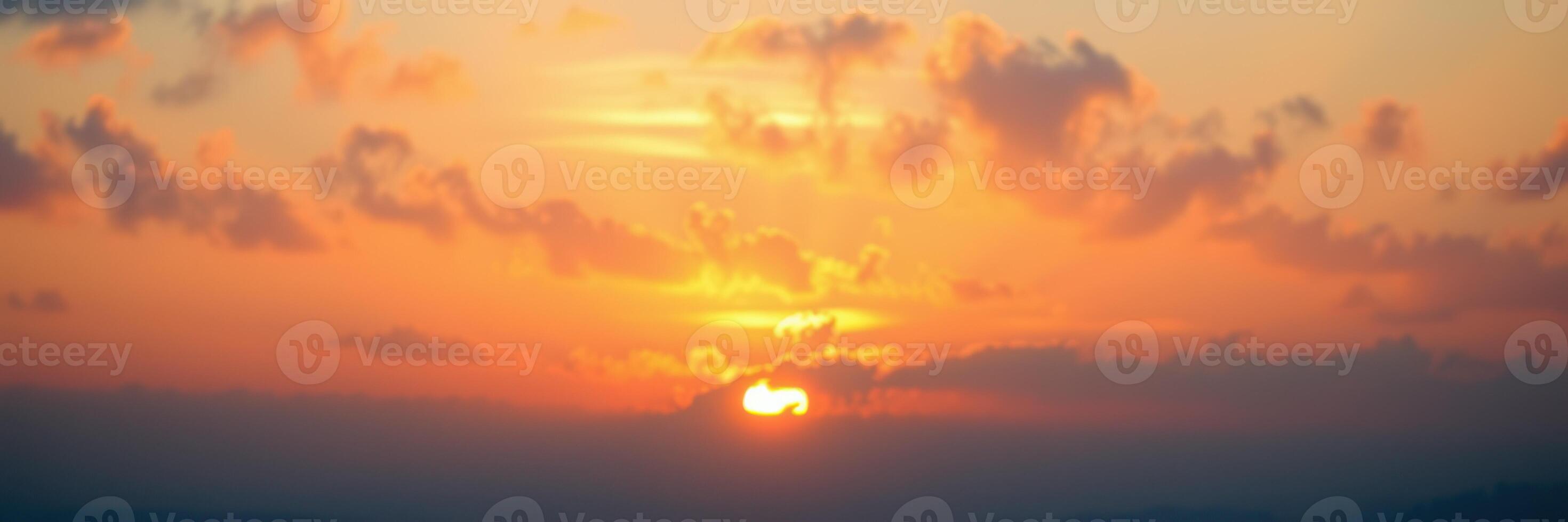 Sunset view from a mountain overlooking the valley with vibrant colors and soft clouds in the sky photo