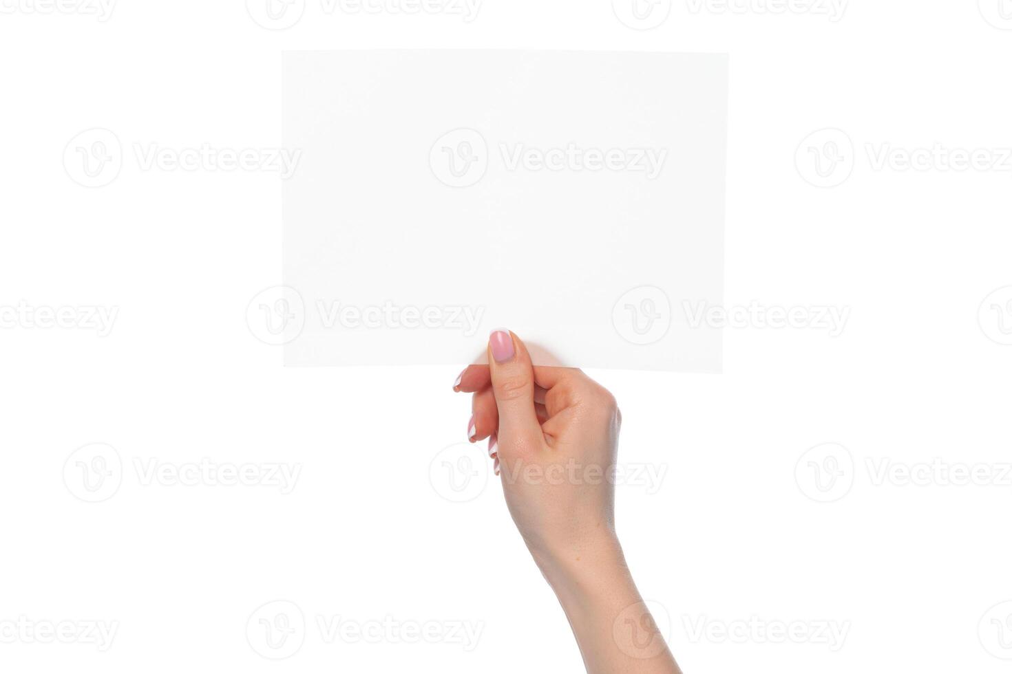 Female hand holding blank white sheet of paper isolated on white photo
