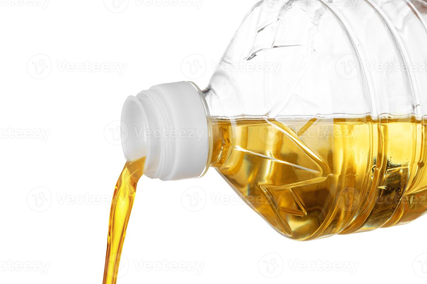 Pouring oil for cooking in a bottle isolated on white background. photo