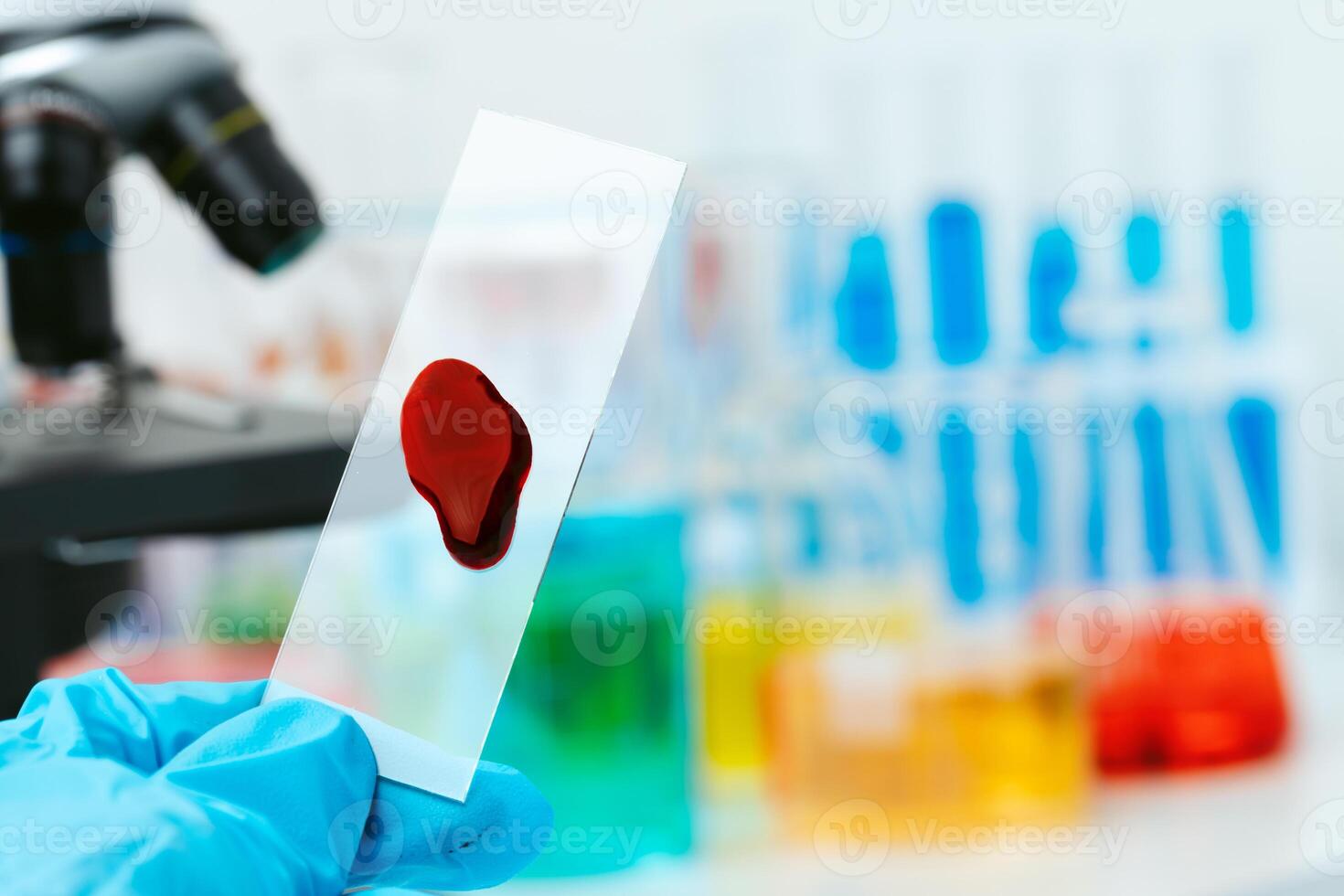 Scientific laboratory with microscope and test tubes with samples, close up photo