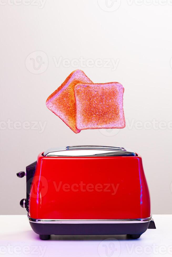 Two toast slices jumping out of toaster in neon light photo