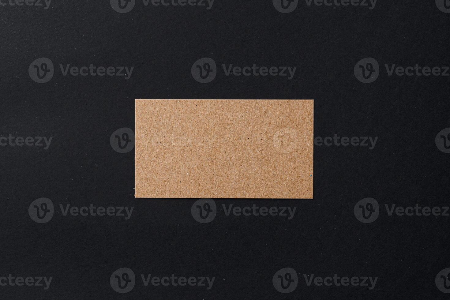 Business card of a craft paper on black background photo