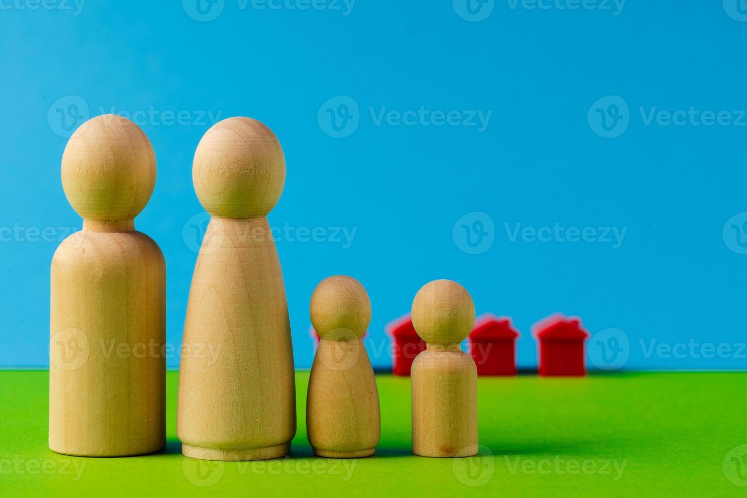 Wooden little family toys. House purchase, sale, rent concept photo
