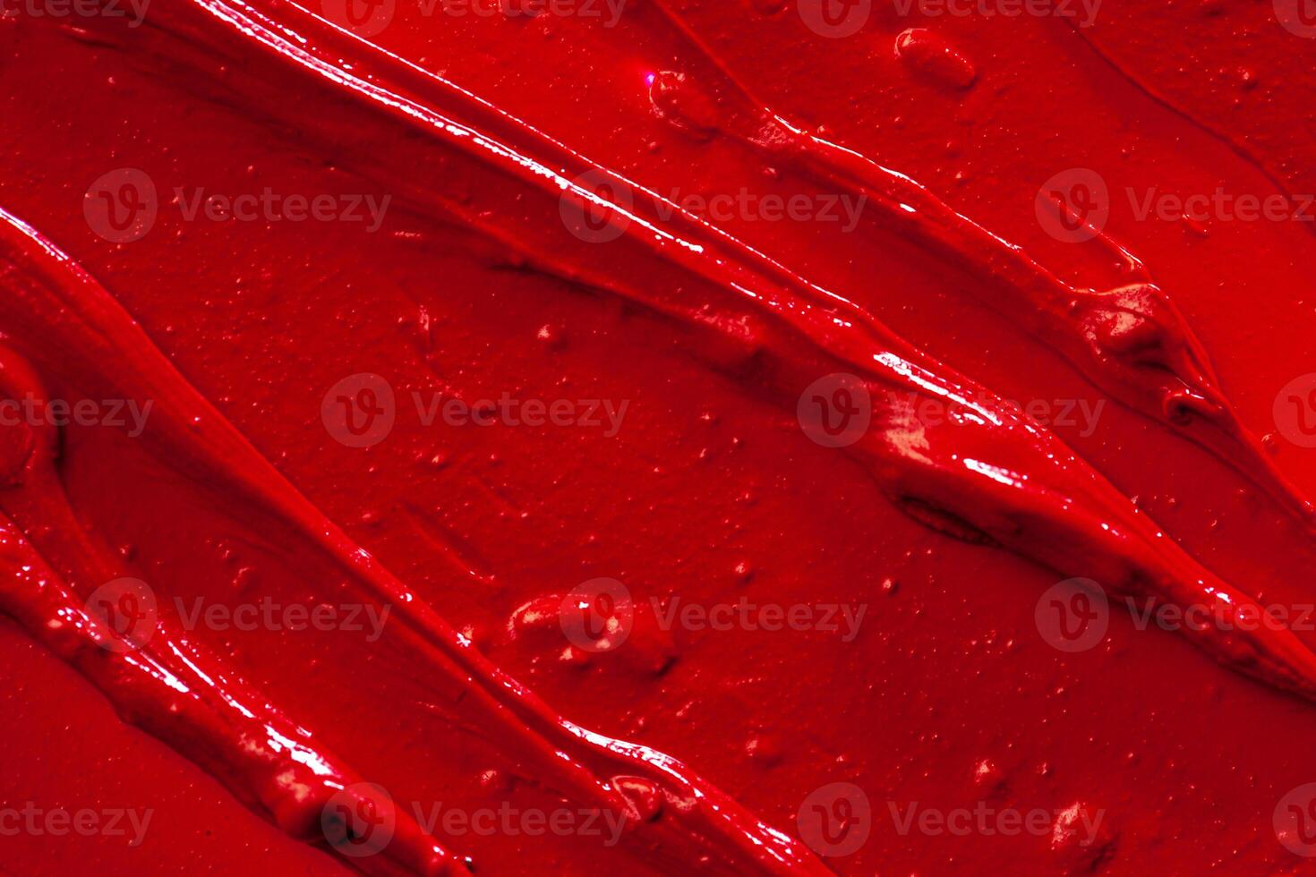 Red lipstick background texture smudged. Close up. photo