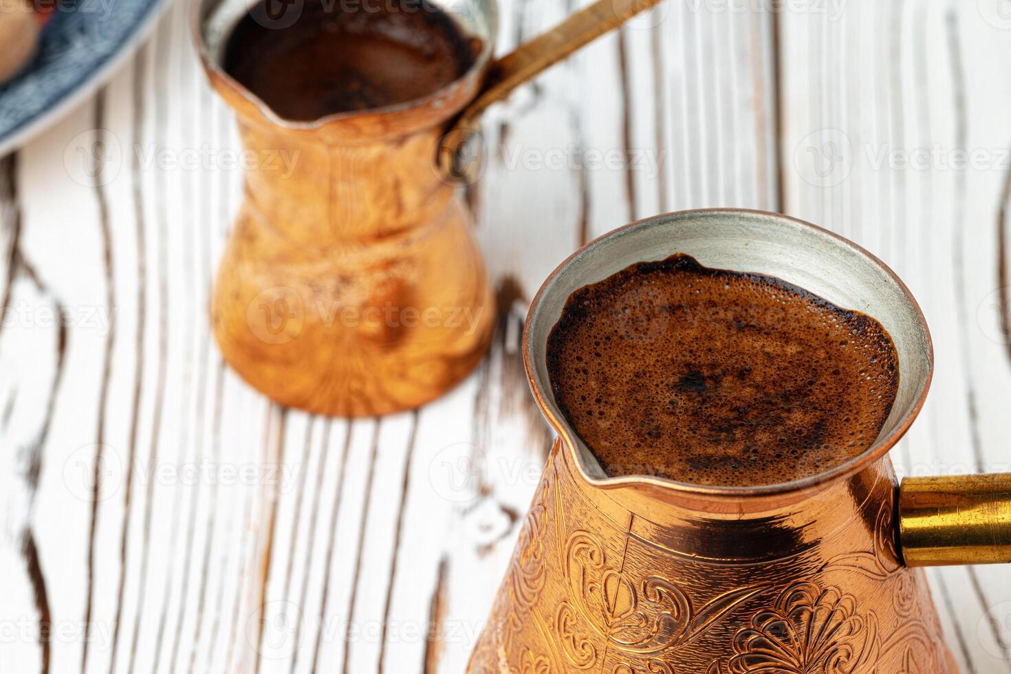 Coffee in metal turk with spices in a plate photo