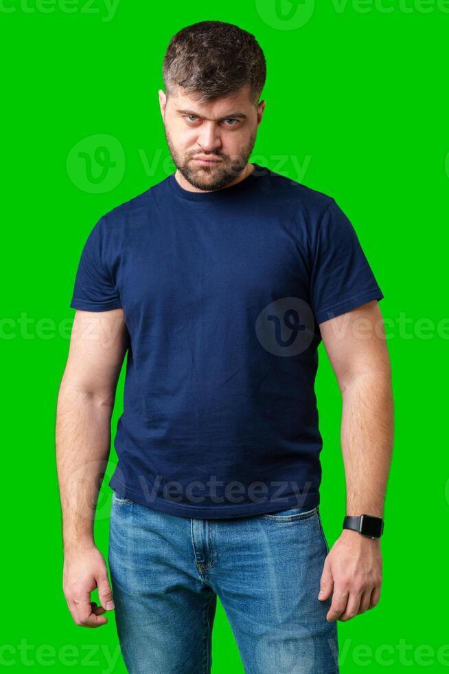 Man expressing confusion with crossed arms in front of a bright green background photo