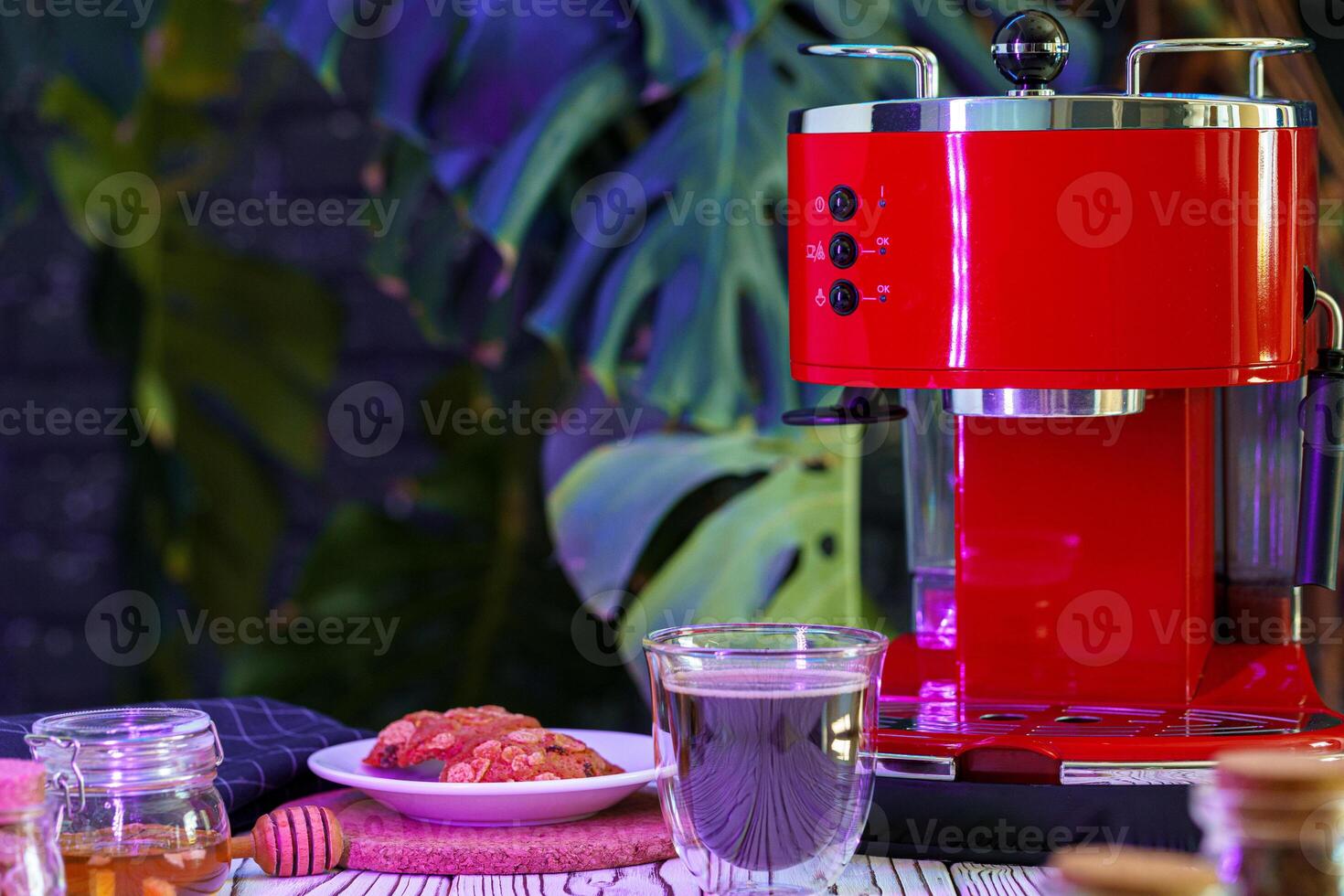 Red coffee machine with a glass on kitchen counter photo