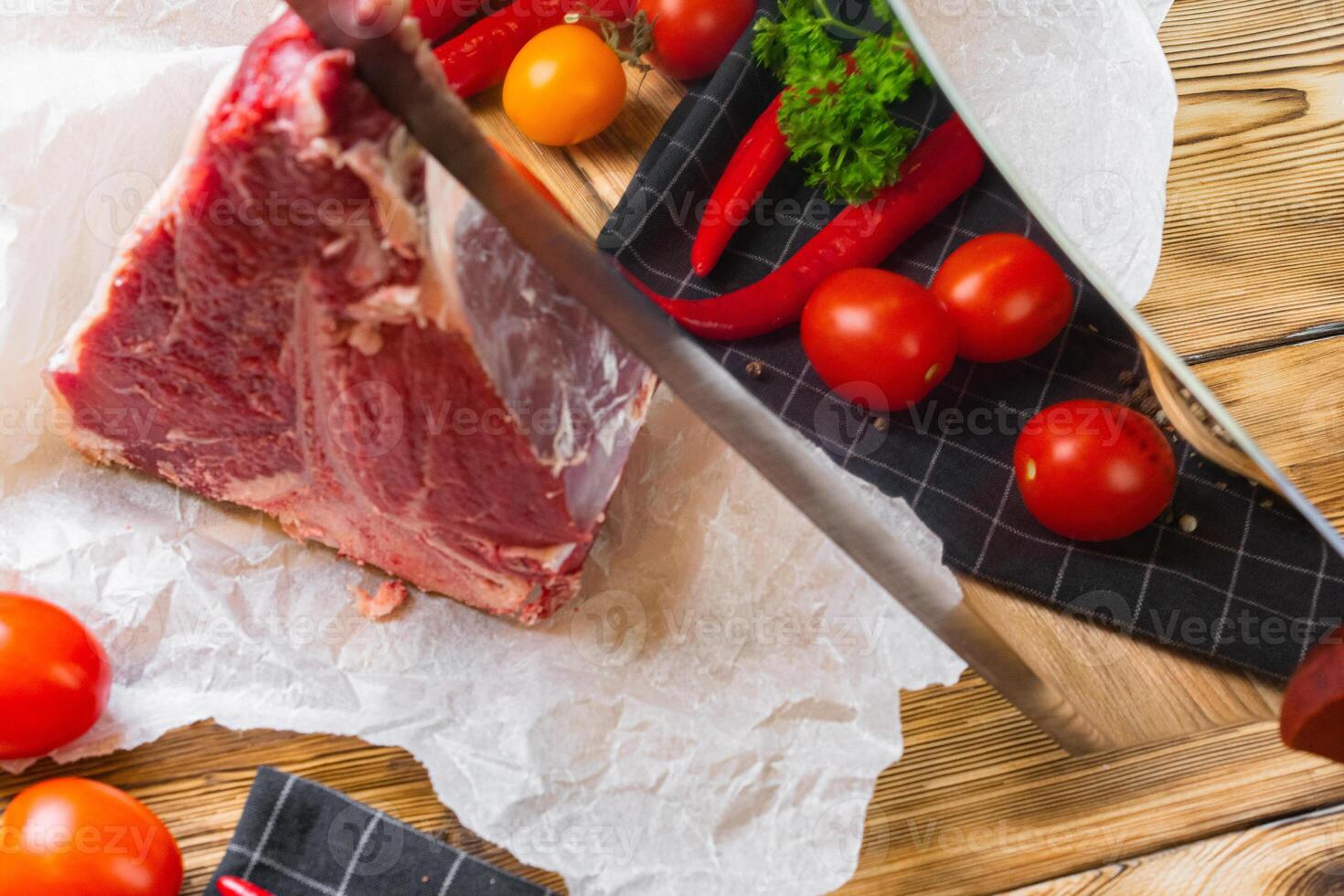 Raw T-bone steak with herbs on wooden board photo