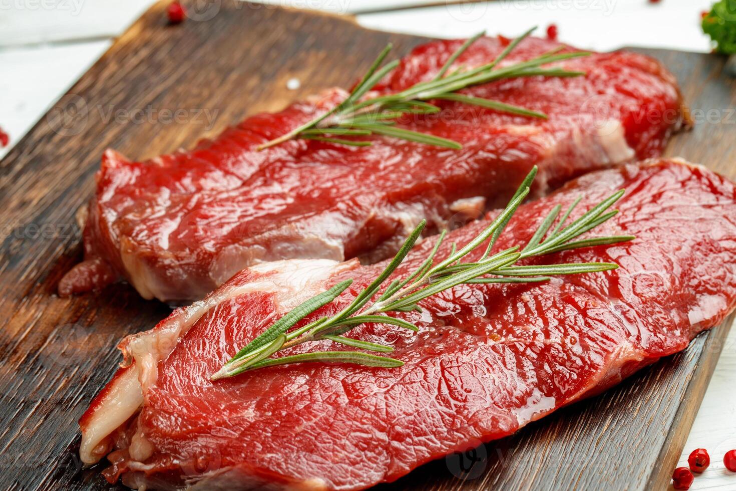 Barbecue veal steaks with rosemary on wooden board photo
