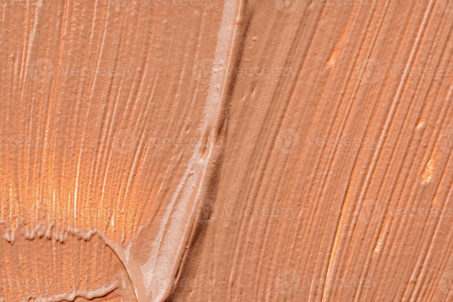 Background of a smudged cream foundation texture photo