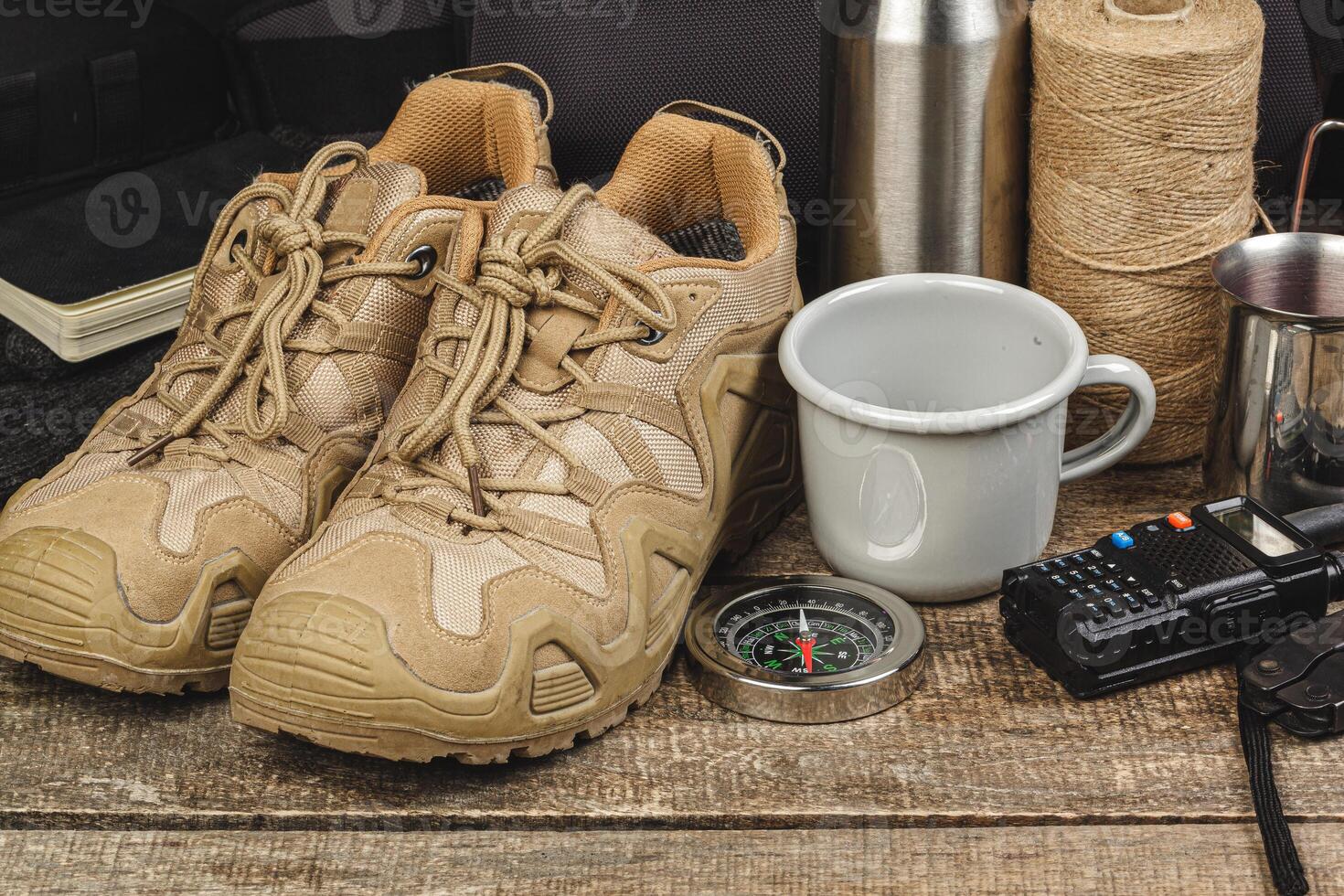 Equipment set for traveler including hiking boots and walki-talkie photo
